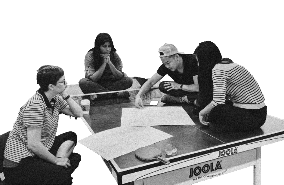 Workers collaborating on a ping-pong table.